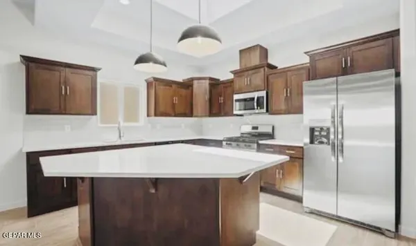 a kitchen with a sink a refrigerator and a stove