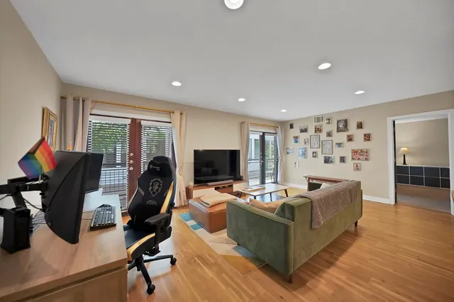 a living room with furniture and wooden floor