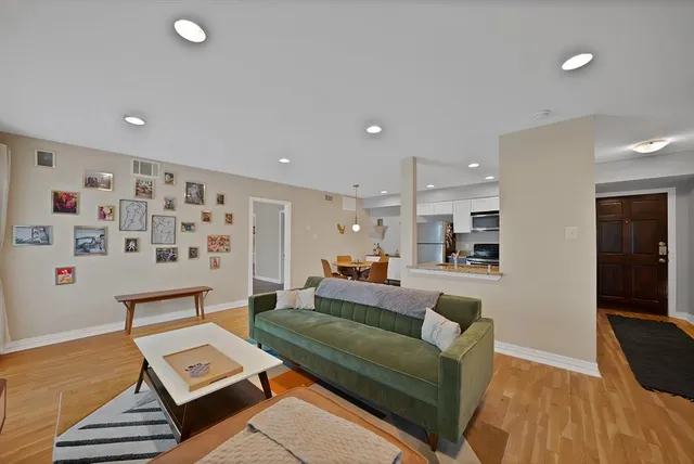 a large kitchen with kitchen island a large counter top space a sink stainless steel appliances and cabinets