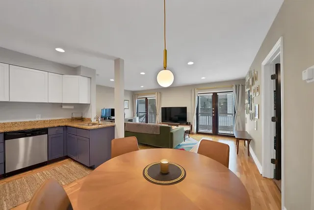 a kitchen with stainless steel appliances white cabinets and a refrigerator
