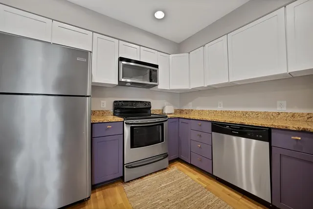 a kitchen with stainless steel appliances granite countertop a sink stove and microwave