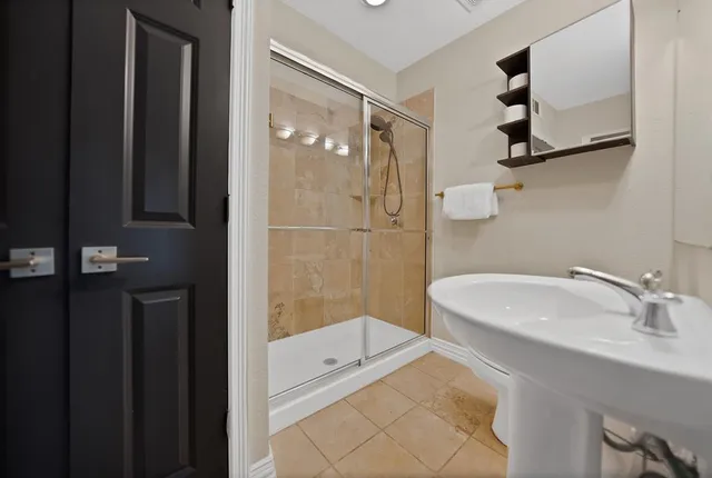 a bathroom with a sink toilet and shower