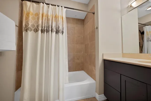 a white toilet sitting next to a bath tub shower