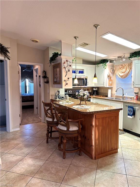 4730 Lantern Lane West Estero, FL 33928 - Photo 13 of 22 a kitchen with a dining table and chairs