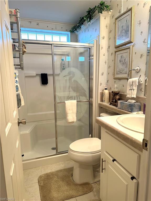 4730 Lantern Lane West Estero, FL 33928 - Photo 16 of 22 a bathroom with a shower a toilet and a sink