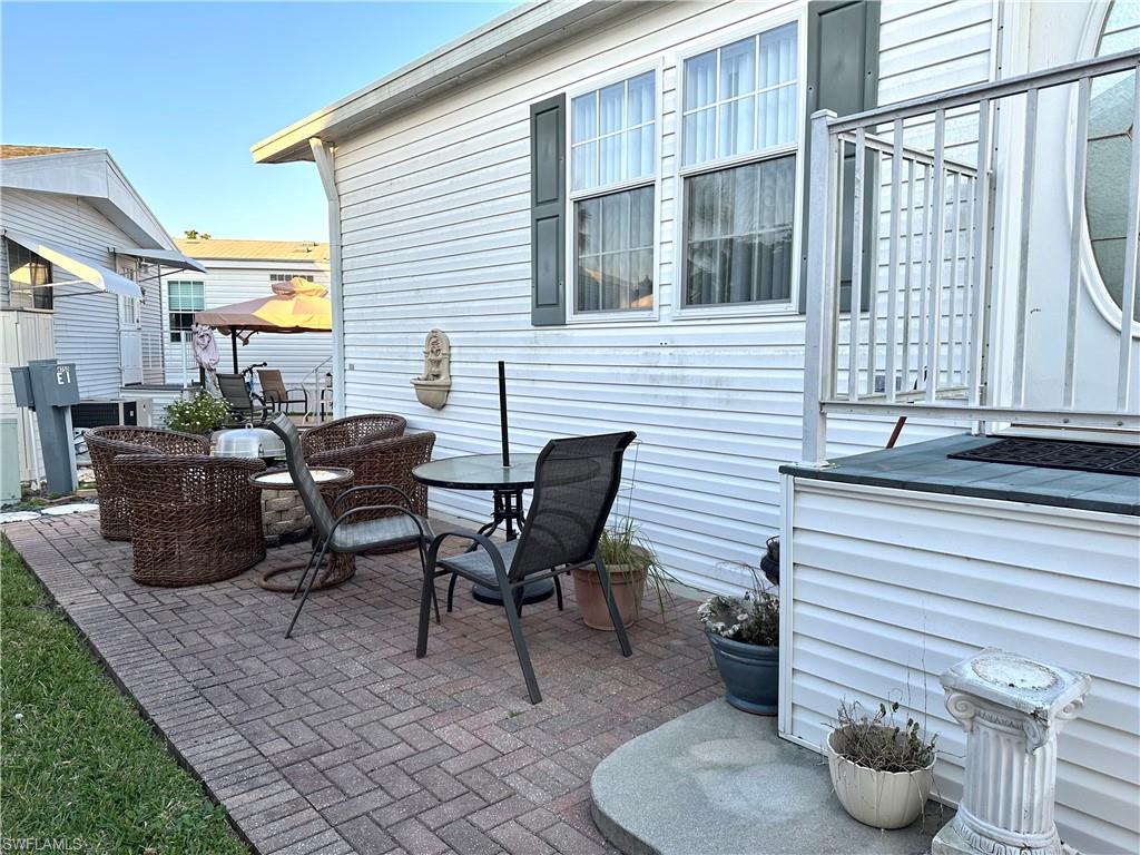 4730 Lantern Lane West Estero, FL 33928 - Photo 2 of 22 a view of a patio with chairs and a potted plant