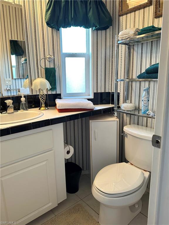4730 Lantern Lane West Estero, FL 33928 - Photo 21 of 22 a bathroom with a sink toilet and a mirror