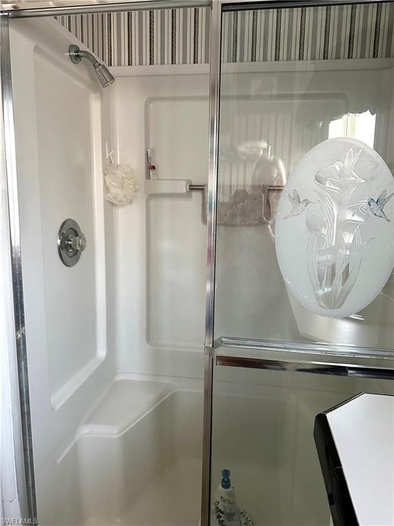 4730 Lantern Lane West Estero, FL 33928 - Photo 22 of 22 a bathroom with a glass shower door