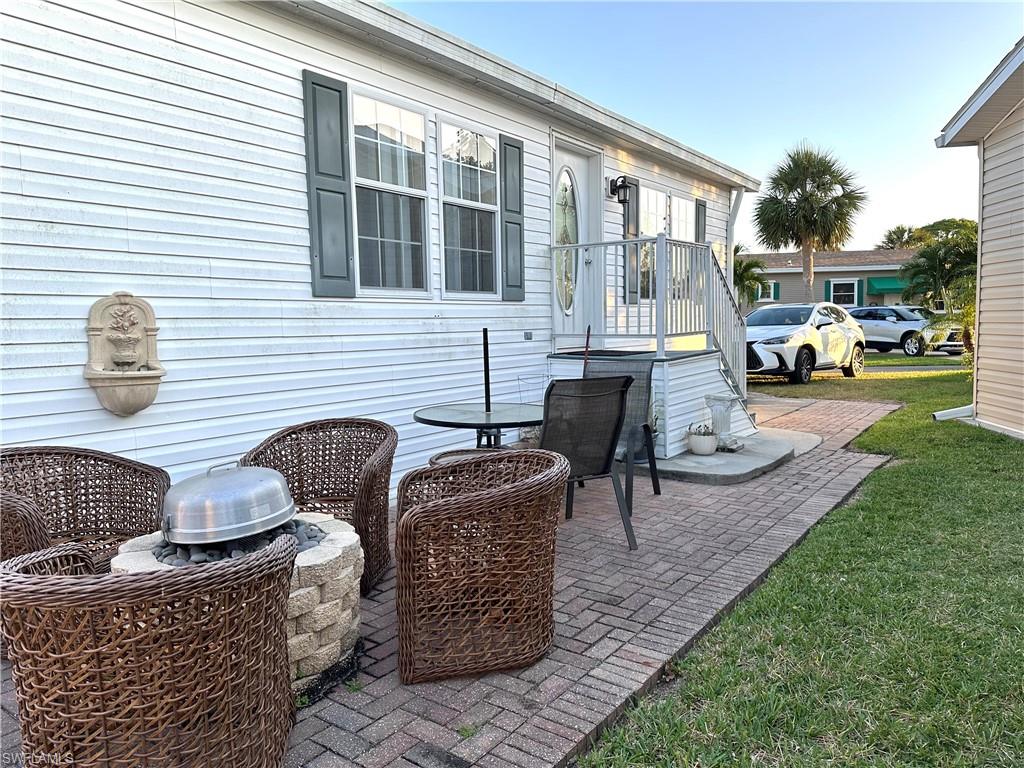 4730 Lantern Lane West Estero, FL 33928 - Photo 3 of 22 a couple of chairs sitting in backyard of house