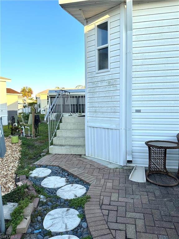 4730 Lantern Lane West Estero, FL 33928 - Photo 4 of 22 a view of a chairs and table in backyard