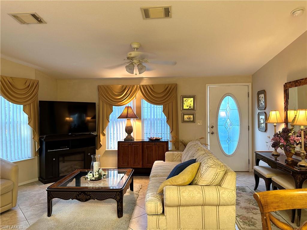 4730 Lantern Lane West Estero, FL 33928 - Photo 7 of 22 a living room with furniture and a flat screen tv