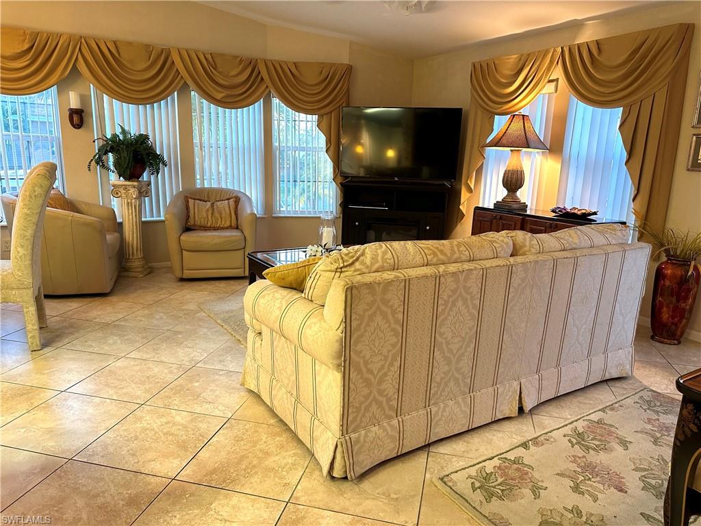 4730 Lantern Lane West Estero, FL 33928 - Photo 9 of 22 a bedroom with a bed and a couch