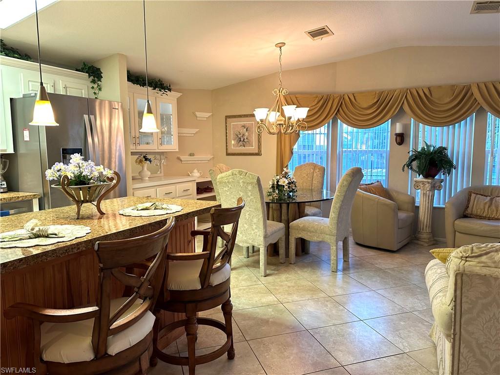 4730 Lantern Lane West Estero, FL 33928 - Photo 10 of 22 a dining room filled with lots of furniture and a chandelier