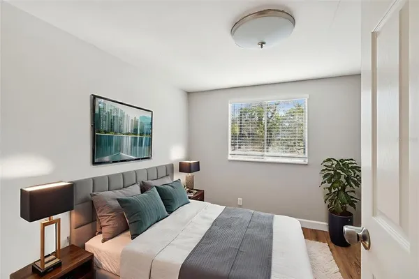 a bedroom with a bed and a window