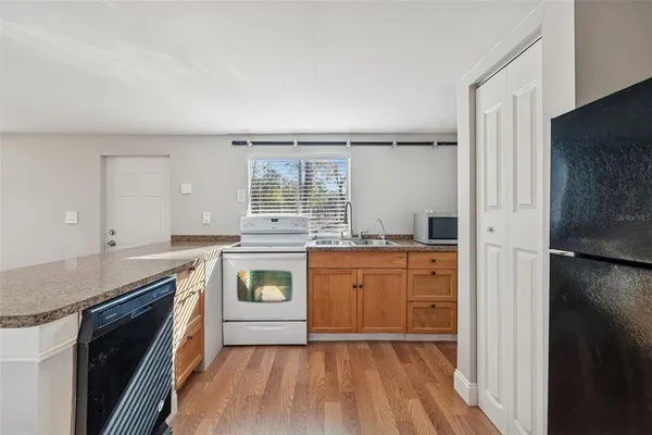 a kitchen with stainless steel appliances granite countertop a stove and a sink