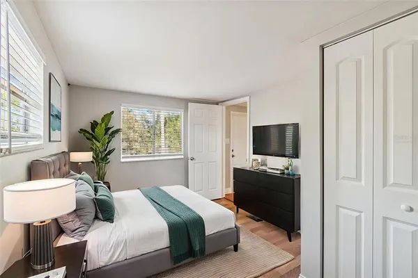 a bedroom with a bed and a television