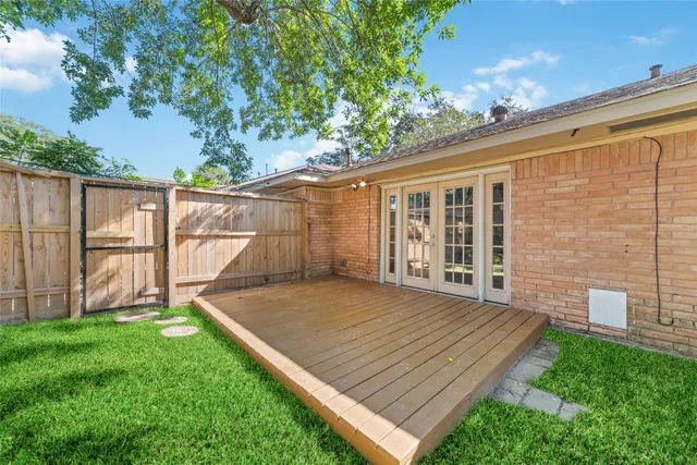 a view of a yard with wooden fence