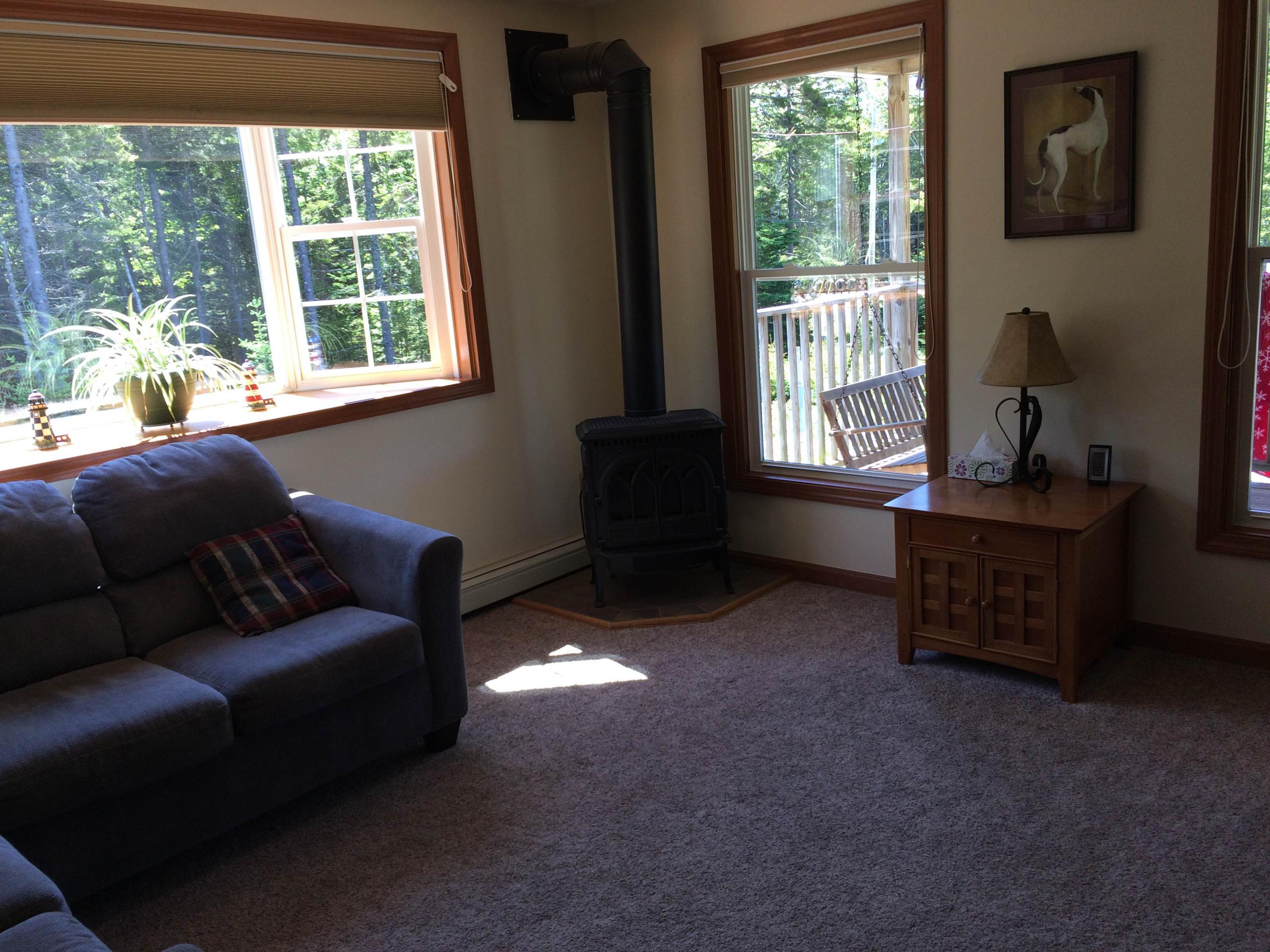 130 Bass Harbor Woods Road Bass Harbor, ME 04653 - Photo 12 of 41 Living room with propane heat stove