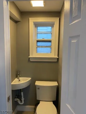a white toilet sitting next to a bathroom sink