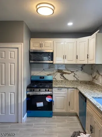 a kitchen with stainless steel appliances granite countertop a stove and a sink
