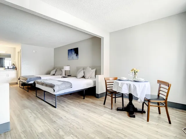 a bedroom with a bed and a table in it