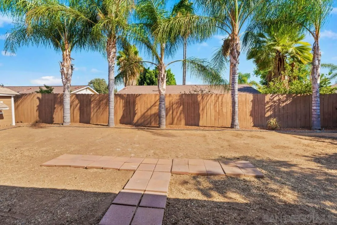 1445 Ronda Place Escondido, CA 92027 - Photo 15 of 15 a row of palm trees sitting in a backyard of a house