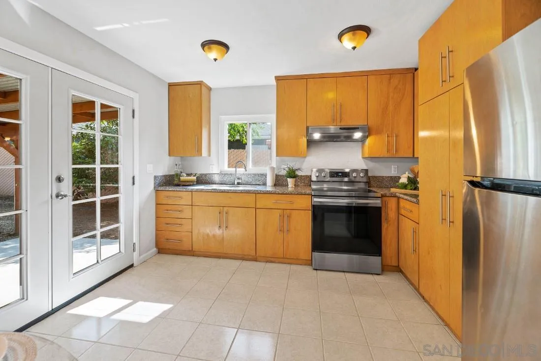 1445 Ronda Place Escondido, CA 92027 - Photo 6 of 15 a kitchen with stainless steel appliances granite countertop a stove a refrigerator and a sink