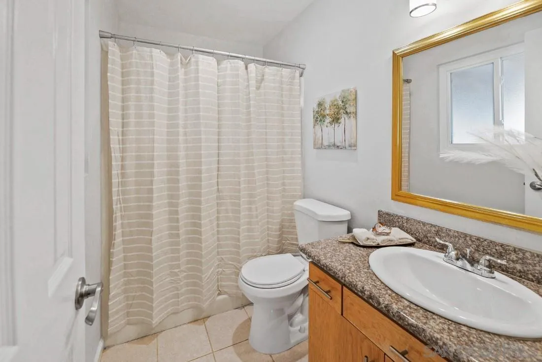 1445 Ronda Place Escondido, CA 92027 - Photo 10 of 15 a bathroom with a granite countertop toilet a sink and a mirror