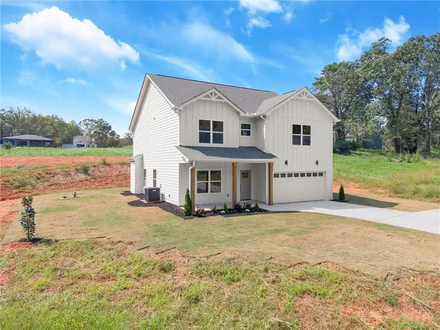 a view of a house with backyard and lake view