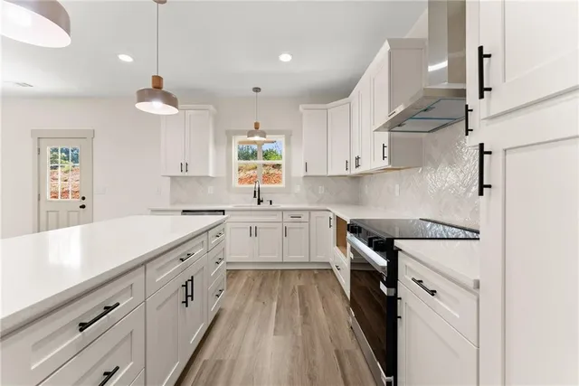 a kitchen with a white cabinets stove and refrigerator