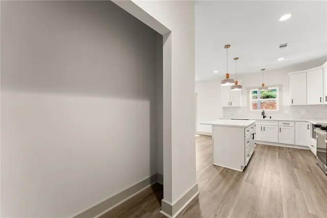 a kitchen with white cabinets and white appliances