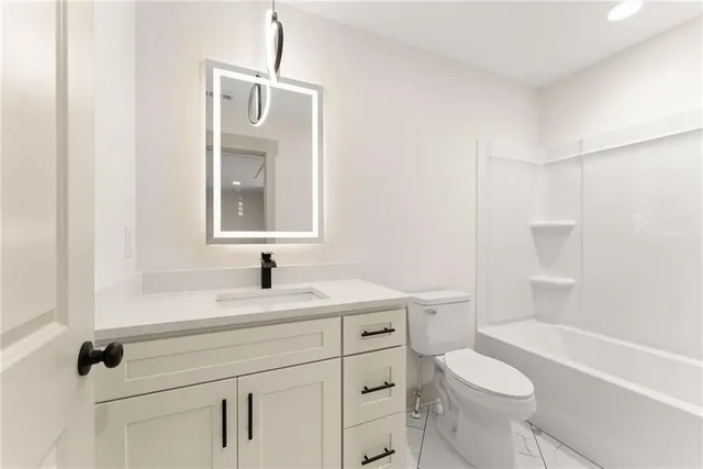 a bathroom with a sink a toilet and a bathtub