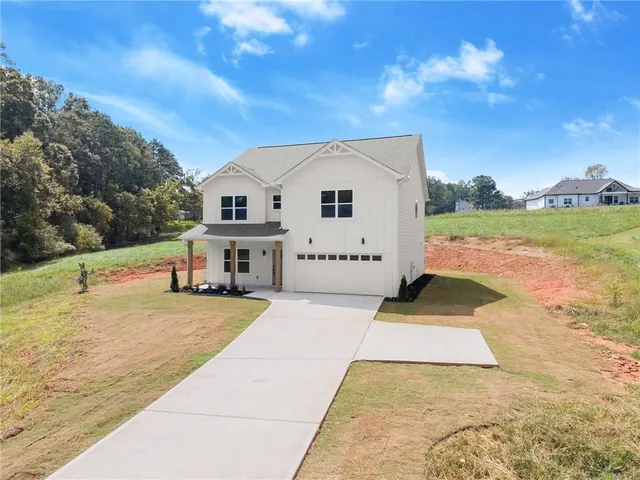 a view of a house with pool and a yard