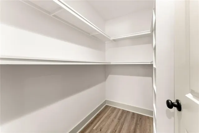 a view of a closet with wooden floor