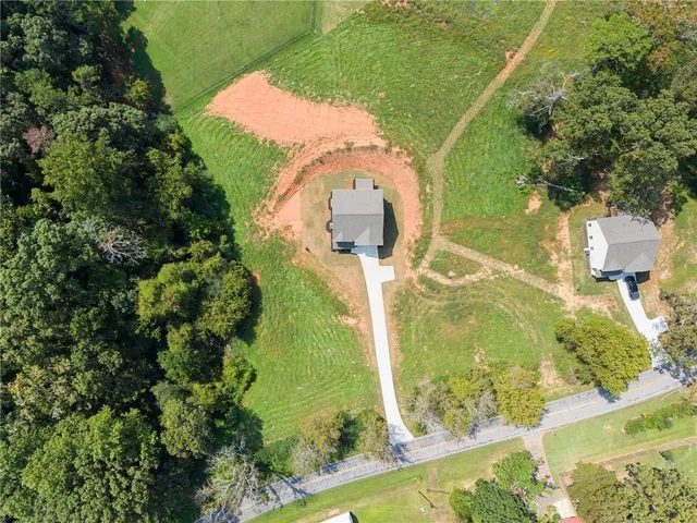 an aerial view of a residential houses with outdoor space and swimming pool