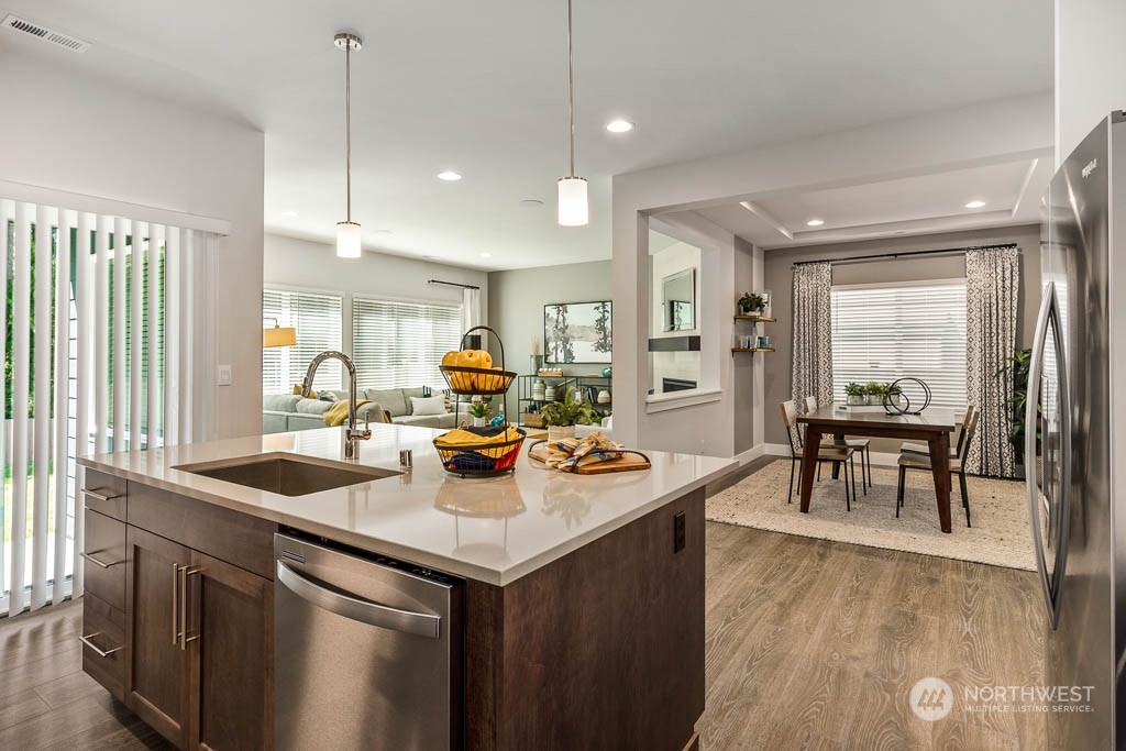 21535 6th Drive Southeast, Unit RM15 Bothell, WA 98021 - Photo 12 of 26 a kitchen with a sink a counter top space and living room view