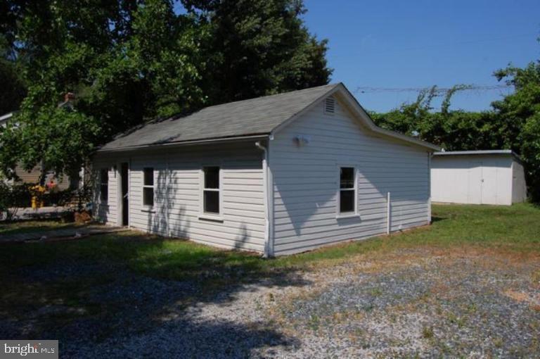 a front view of house with backyard and green space