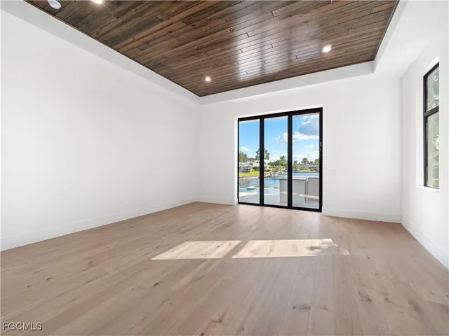 a view of a lake with a big yard and potted plants
