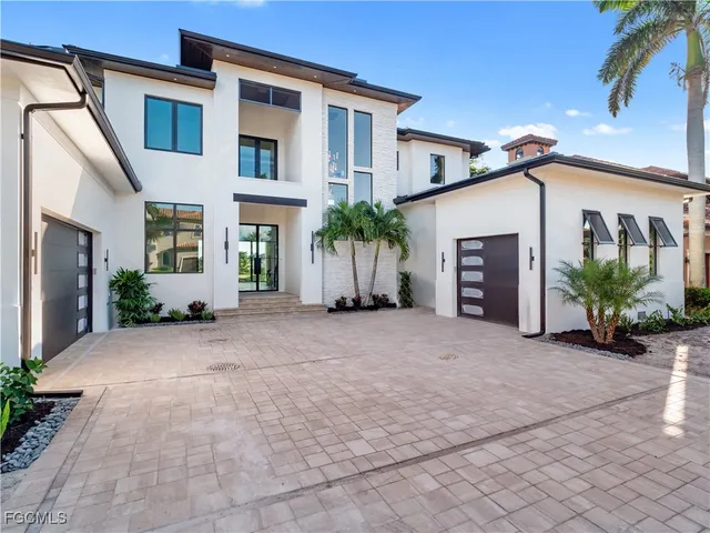 an aerial view of a house with a swimming pool outdoor seating and yard