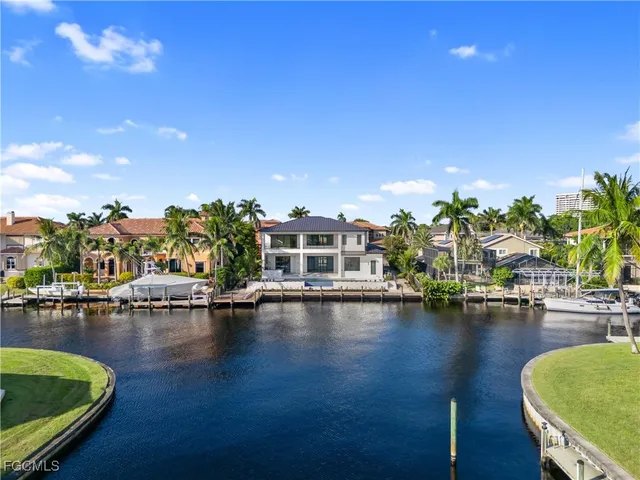 a front view of a house with swimming pool and sitting area