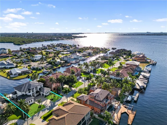 a large kitchen with a large counter top stainless steel appliances and cabinets