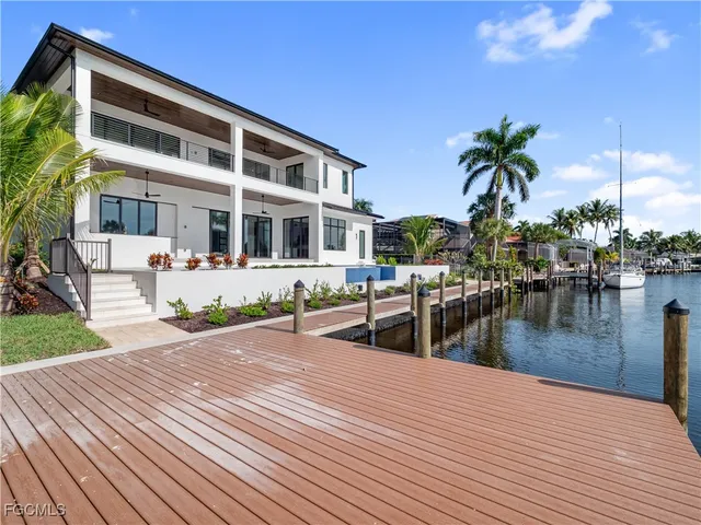 a large kitchen with a large counter top stainless steel appliances and cabinets