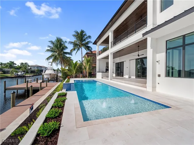 a view of an empty room with a window and fireplace