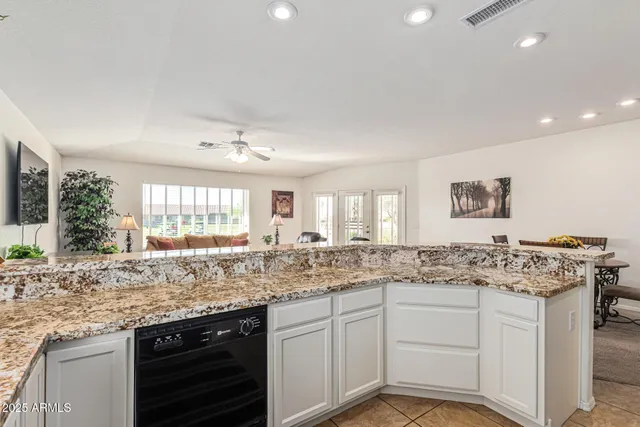 a kitchen with granite countertop a refrigerator stove and microwave