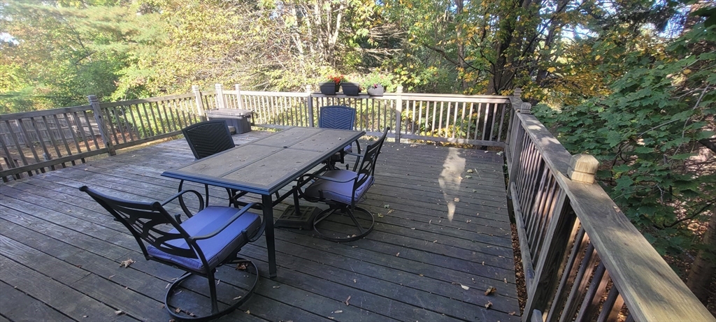 123 West River Road Hooksett, NH 03106 - Photo 20 of 40 a view of balcony with wooden floor and outdoor seating