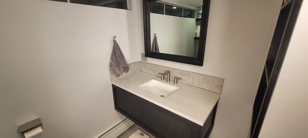 123 West River Road Hooksett, NH 03106 - Photo 23 of 40 a bathroom with a sink and a mirror