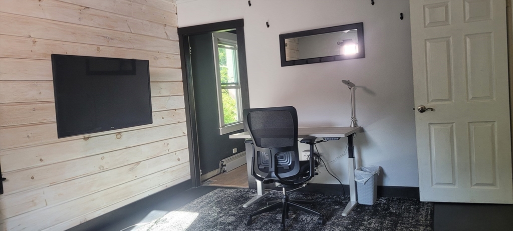 123 West River Road Hooksett, NH 03106 - Photo 28 of 40 a view of a workspace with furniture and wooden floor