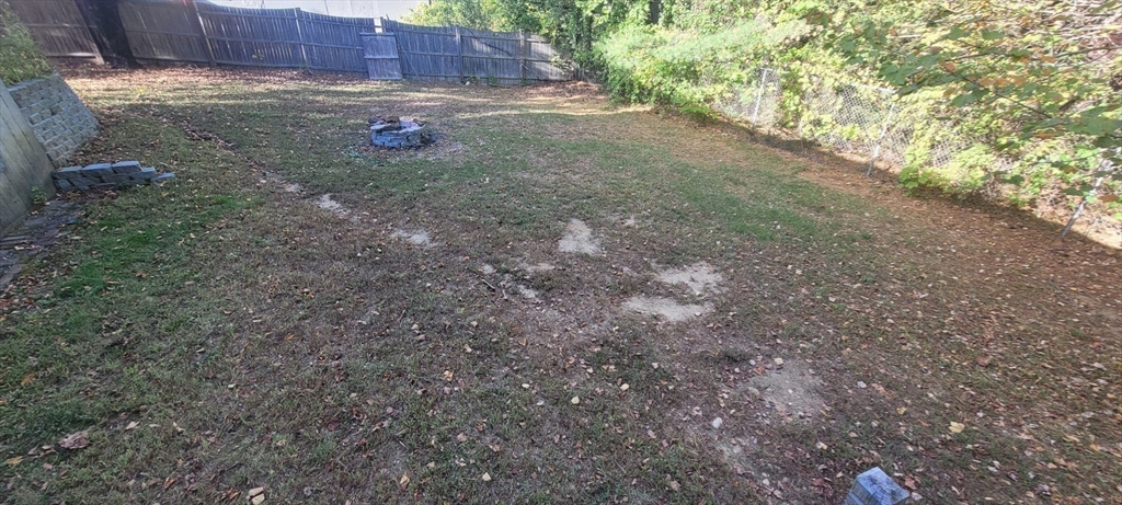123 West River Road Hooksett, NH 03106 - Photo 38 of 40 a view of a backyard with large tree and wooden fence