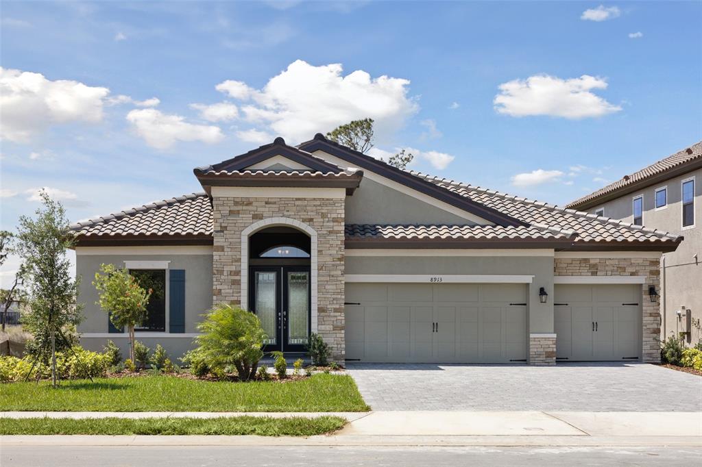 a front view of a house with a garden