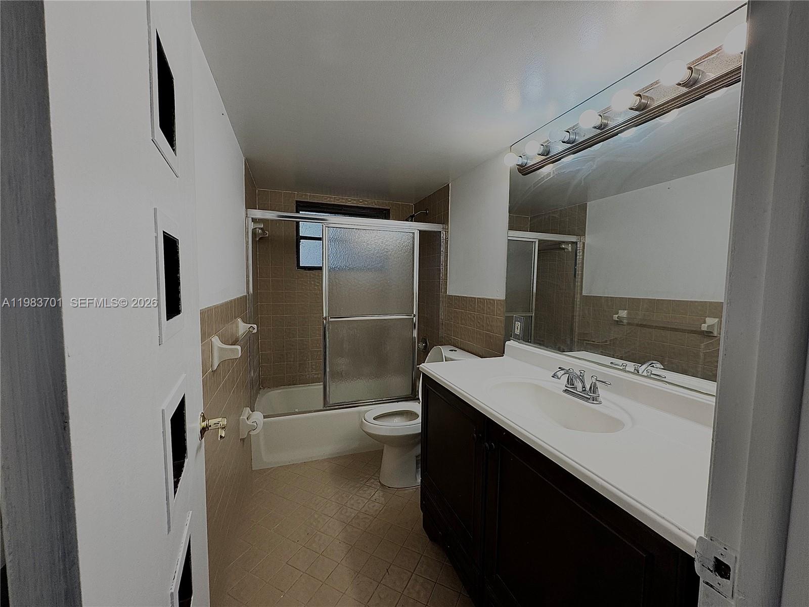 3911 Farragut Street Hollywood, FL 33021 - Photo 12 of 26 a bathroom with a sink toilet and shower